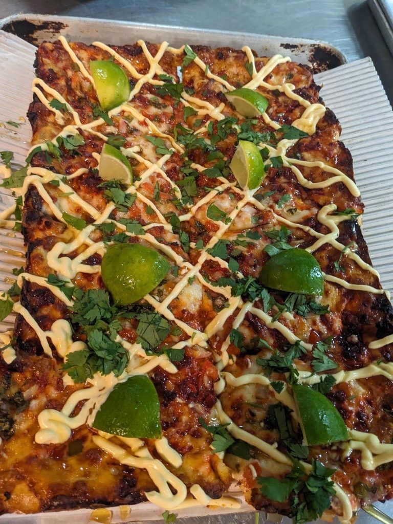 Picture of Detroit style pizza with cilantro and lime toppings